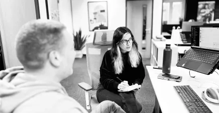 Employees at digital agency Candour discussing work