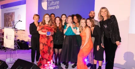 Sony Music UK team collect the Business Culture Awards top prize from compere Jo Caulfield (right) and BCA's Cath Longfield (left)